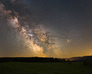 Scenic view of field against sky at night