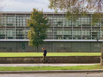 Man walking by building in city