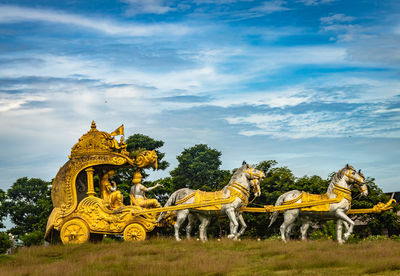 Holly arjuna chariot of mahabharata in golden color with amazing sky background