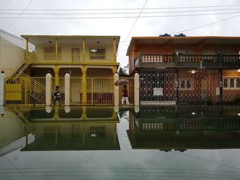 People in front of building against sky