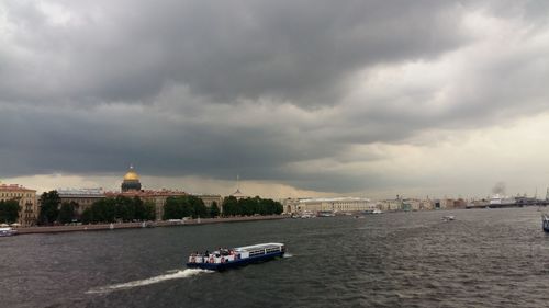 Boat in building against cloudy sky