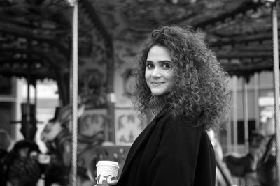 Smiling young woman with curly hair