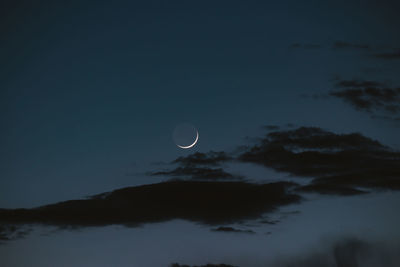 Low angle view of moon in sky at night