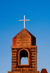 Low angle view of building against clear blue sky