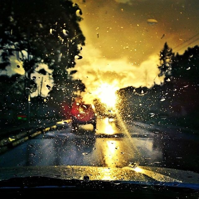 wet, drop, rain, car, water, window, glass - material, transparent, transportation, land vehicle, season, mode of transport, road, raindrop, street, sunset, sky, weather, illuminated, windshield