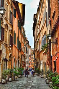 People walking on street amidst buildings in town