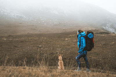 Dog standing in a mountain