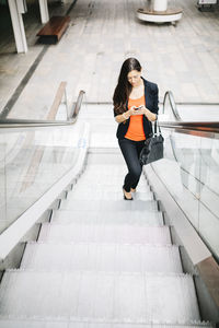 High angle view of woman walking on steps