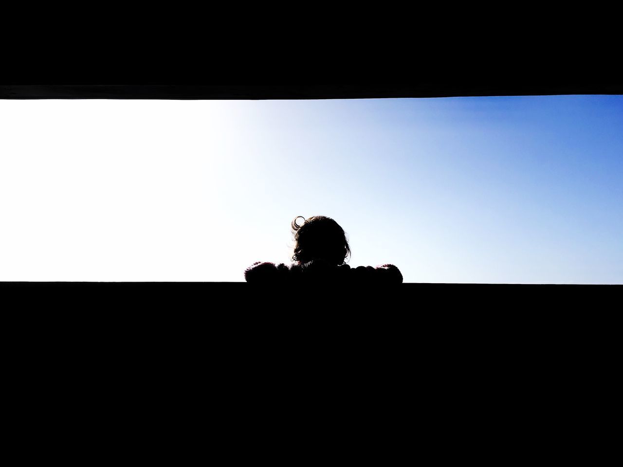 PORTRAIT OF SILHOUETTE MAN ON WINDOW AGAINST CLEAR SKY