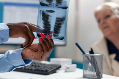 Cropped hands of man working on table