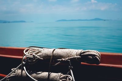 Close-up of rope on boat in sea against sky