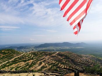 Aerial view of flag on landscape against sky