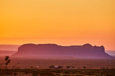 Scenic view of mountains against orange sky