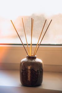 Cozy home decorations aroma reed diffuser in the living room. home comfort concept. bottle container