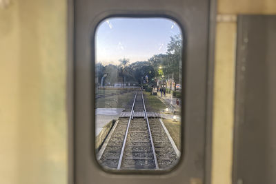 Railroad tracks seen through train window