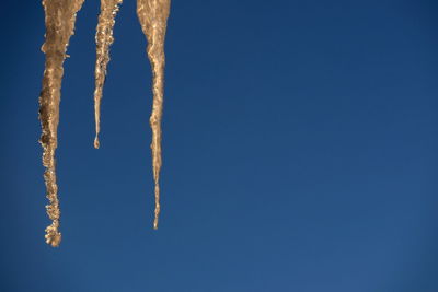 Low angle view of vapor trail against clear blue sky