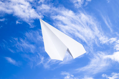 Low angle view of flag against blue sky