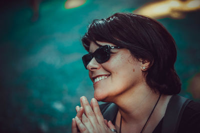 Portrait of smiling young woman wearing sunglasses