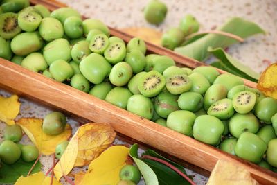 High angle view of kiwis in wooden container