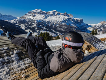 Rear view of man sitting on mountain