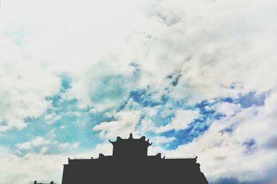 Low angle view of building against cloudy sky