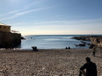 People on beach against sky