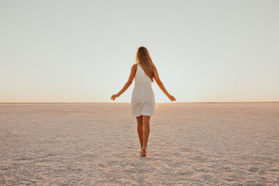 Full length of woman standing at beach