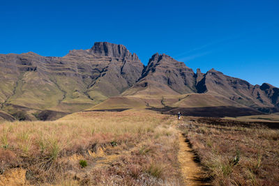 Scenic view of mountains against clear blue sky