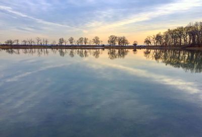 Scenic view of lake against sky at sunset