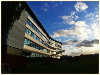 View of buildings against cloudy sky