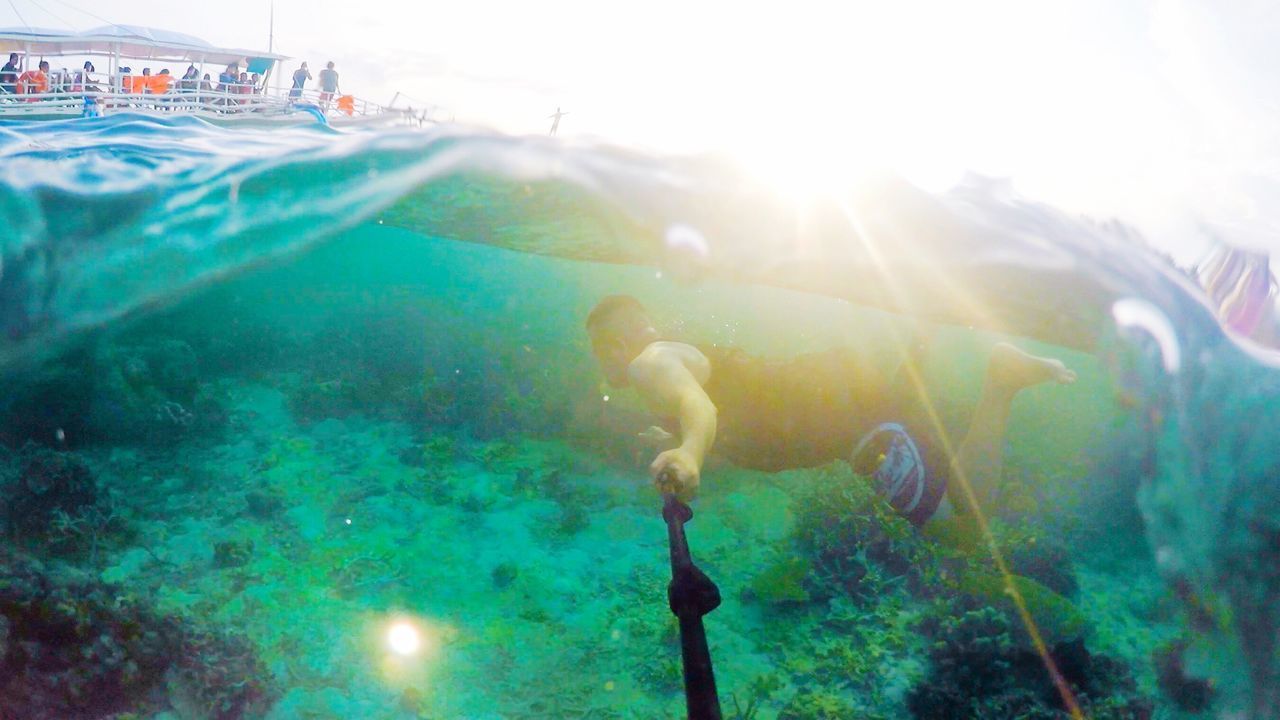 MAN SWIMMING UNDERWATER