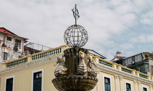 Low angle view of building against cloudy sky