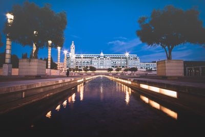 Reflection of illuminated buildings in city