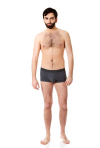 Portrait of young man standing against white background