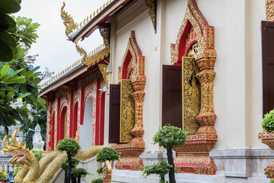 Statues on temple against trees