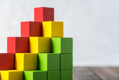 Stack of colorful wooden toy blocks on table