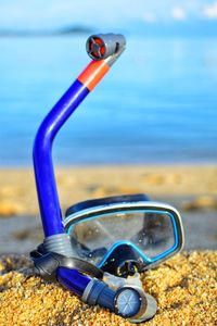 Close-up of sunglasses on beach