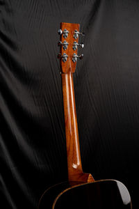 Close-up of guitar on bed