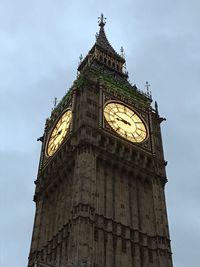 Low angle view of clock tower against sky