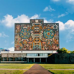 Graffiti on building against cloudy sky