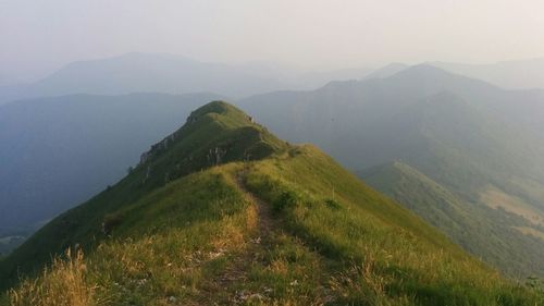 Scenic view of mountains against cloudy sky