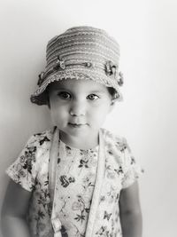 Portrait of cute girl wearing hat against white background