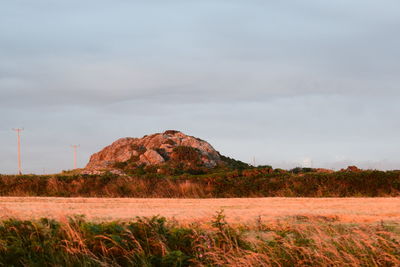 Scenic view of landscape against cloudy sky