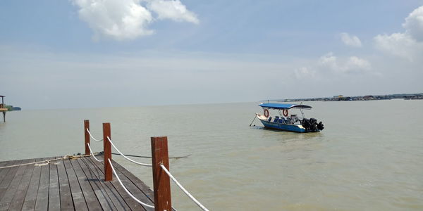 A boat waiting in sea against sky