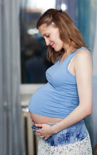 Side view of happy pregnant woman