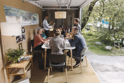 Business people discussing strategy in portable office truck