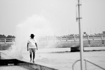 Full length of woman standing against sky