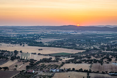 High angle view of buildings against sky during sunset