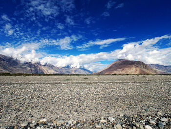 Scenic view of rocky mountains against blue sky