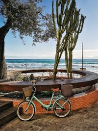 Bicycles on beach against sky